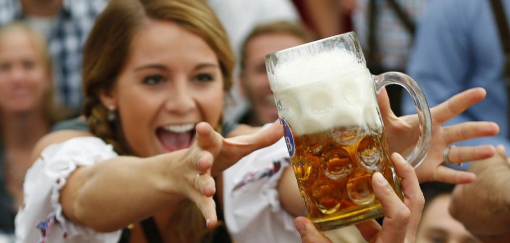 a-visitor-reaches-for-of-the-one-of-the-first-mugs-of-beer-during-opening-ceremo